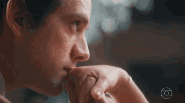 a man is kissing a woman 's hand while holding her hand .