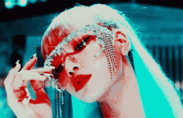 a close up of a woman wearing sunglasses with rhinestones