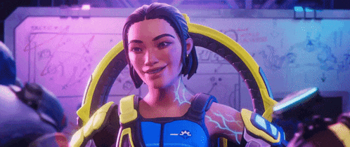a woman in a blue and yellow armor is smiling in front of a whiteboard .