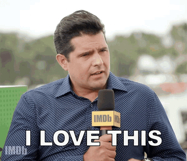 a man holding a microphone with the words i love this on it