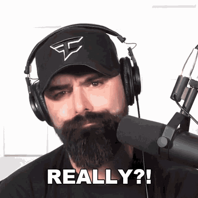a man with a beard wearing headphones says " really "