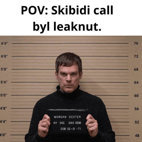morgan dexter is holding a mugshot in front of a measurement board