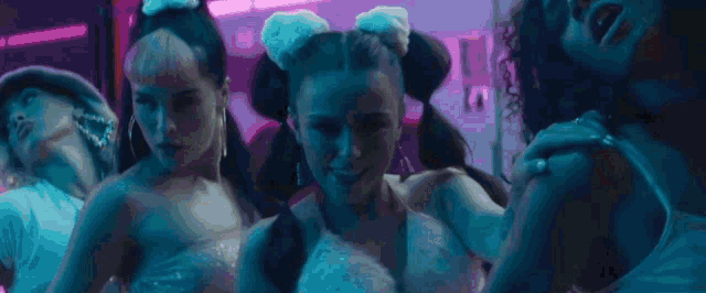 a woman with red lipstick and hoop earrings is dancing with her hands in the air .