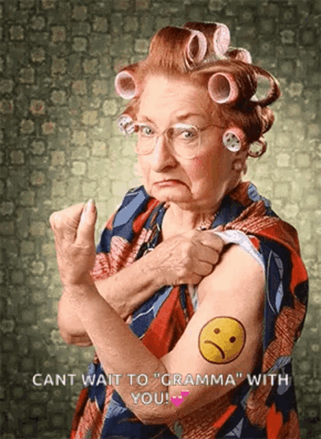 an elderly woman with curlers on her hair has a tattoo of a sad face on her arm