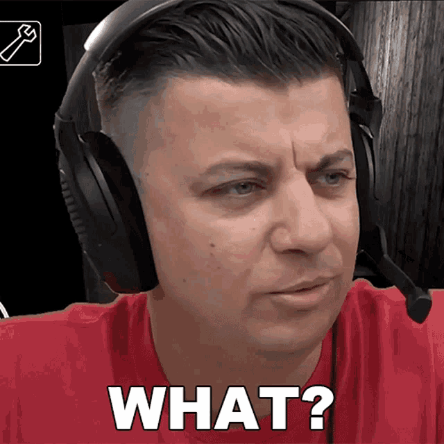 a man wearing headphones says " what " in white letters