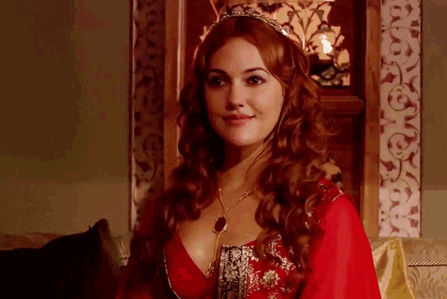 a woman in a red dress with a crown on her head