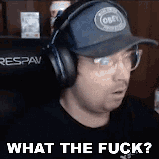 a man wearing headphones and a hat with the words `` what the fuck '' written on it .