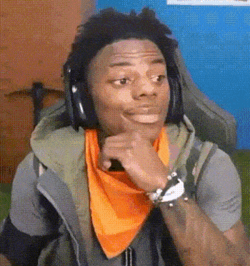 a young man wearing headphones and an orange bandana is making a funny face .