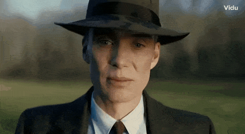 a close up of a man wearing a hat and a suit