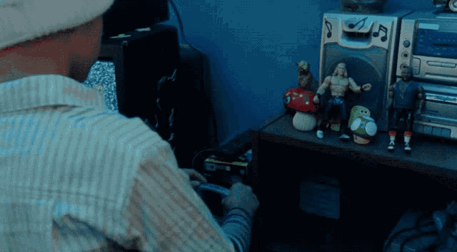 a man is playing a video game in front of a stereo system