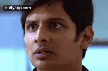 a close up of a man 's face with a surprised expression .