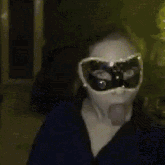 a woman wearing a mask and goggles making a funny face .