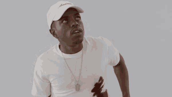 a man wearing a white hat and a white t-shirt with the word america on it