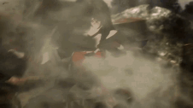 a woman with long black hair is standing in a foggy area