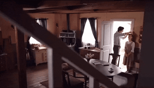 a man and a woman are standing in a room