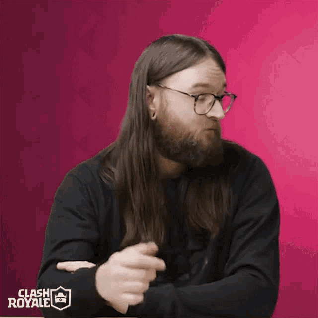 a man with long hair and a beard is wearing glasses