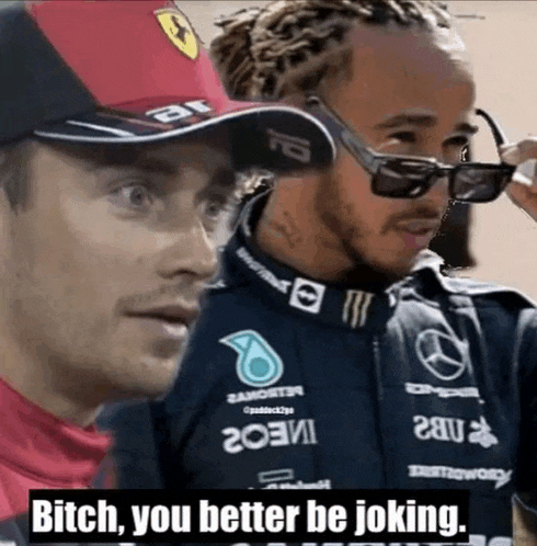 two men are standing next to each other and one of them is wearing sunglasses and a hat that says ferrari
