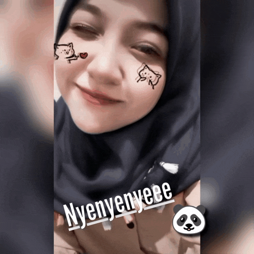 a woman wearing a hijab has a panda sticker on her face that says nyenyeee