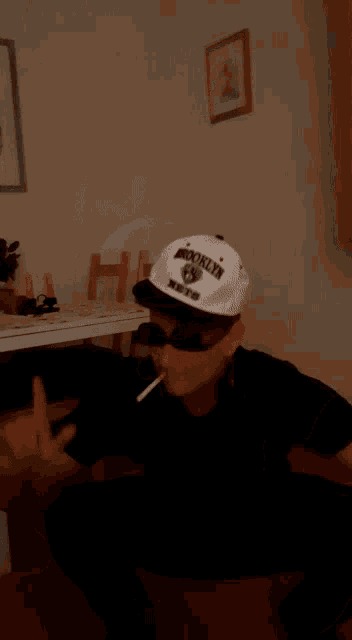 a man wearing a hat that says ' mafia ' on it