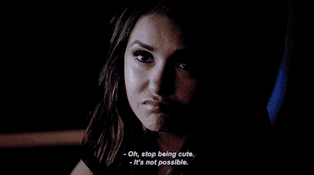 a close up of a woman 's face with the words oh stop being cute and it 's not possible