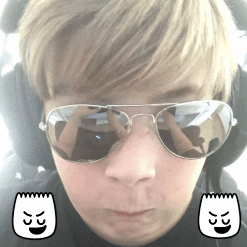 a young boy wearing sunglasses with a bart icon on his face