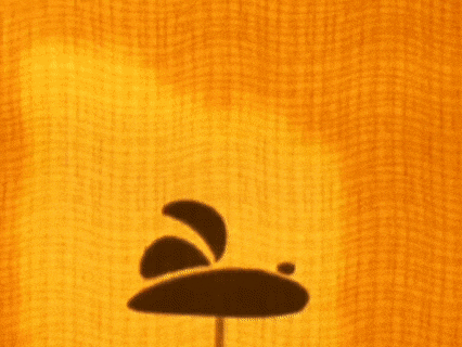 shadows of cartoon characters are cast on a yellow wall