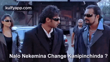 three men in suits and sunglasses are standing next to each other .