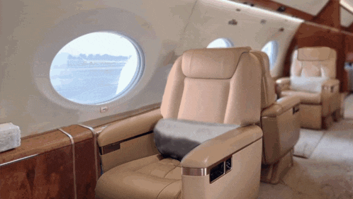 the inside of an airplane with a round window and seats