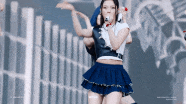a woman in a blue skirt is singing into a microphone with the words wish written below her