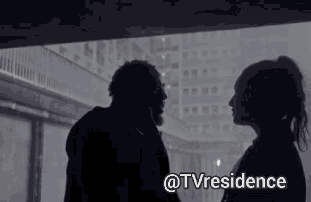 a man and a woman are looking at each other in a dark room with the words tvresidence above them