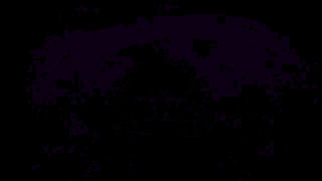 a purple lightning bolt is coming out of the ground in a dark room .