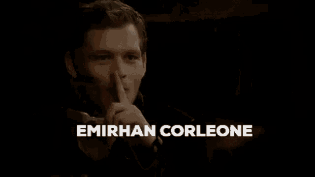 a close up of a man 's face with the name emirhan corleone written on the bottom .
