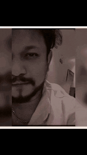 a black and white photo of a man with a beard and mustache