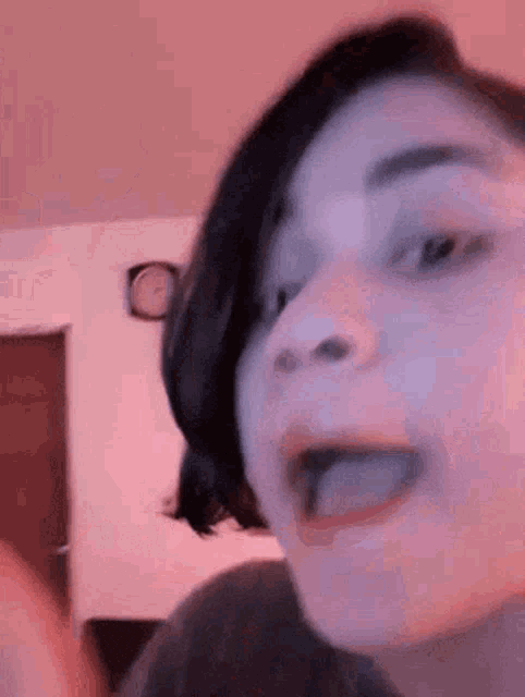 a close up of a person 's face with their tongue sticking out .