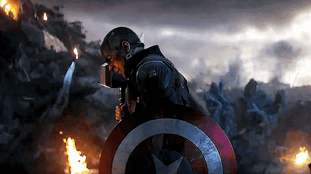 captain america is holding a shield and a hammer in a scene from the movie avengers : endgame .