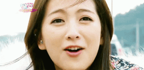 a close up of a woman 's face with her mouth open
