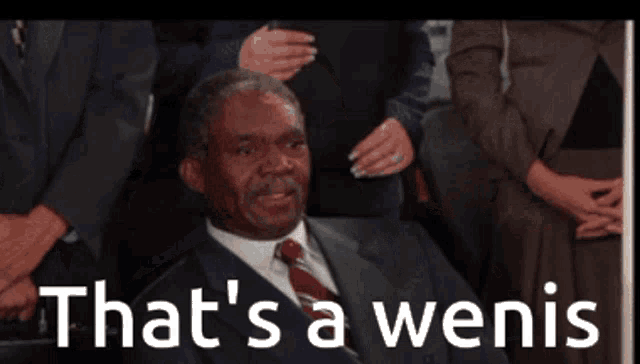 a man in a suit and tie with the words that 's a wenis below him