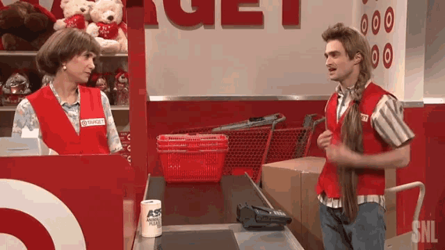 a woman in a target uniform talks to a man in a target store