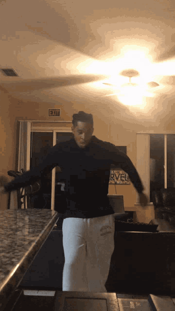 a man is dancing in front of a sign that says river