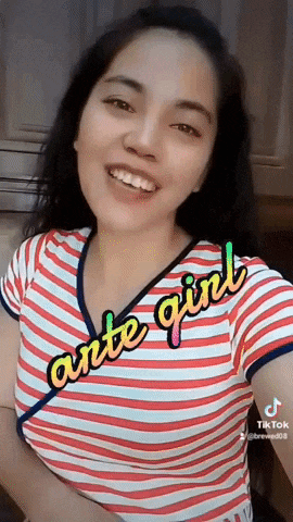 a woman wearing a striped shirt with the words ante girl on it