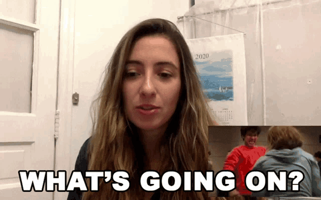 a woman is asking what 's going on in front of a calendar