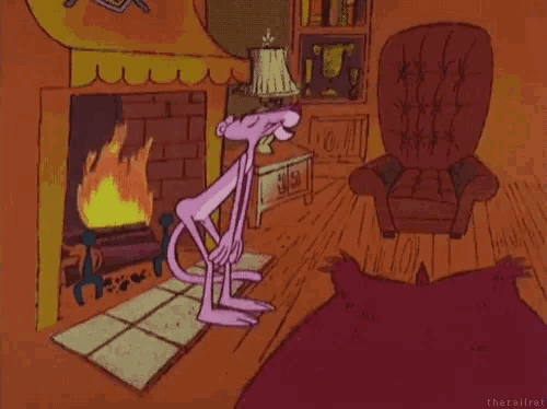 a pink panther is standing in front of a fireplace .