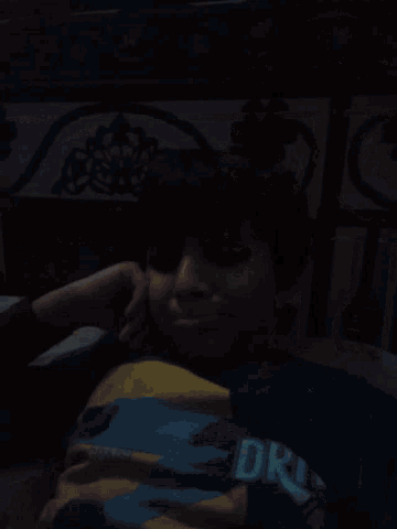 a boy wearing a blue and yellow shirt that says ' dr ' on it
