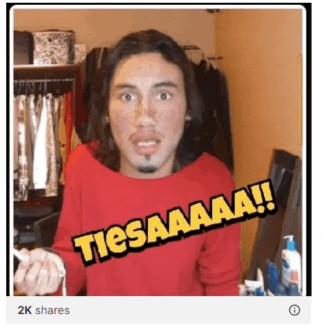 a man wearing a red sweater with the words tiesaaaaa written on it