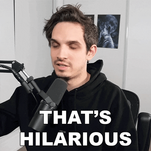 a man sitting in front of a microphone with the words that 's hilarious on the bottom
