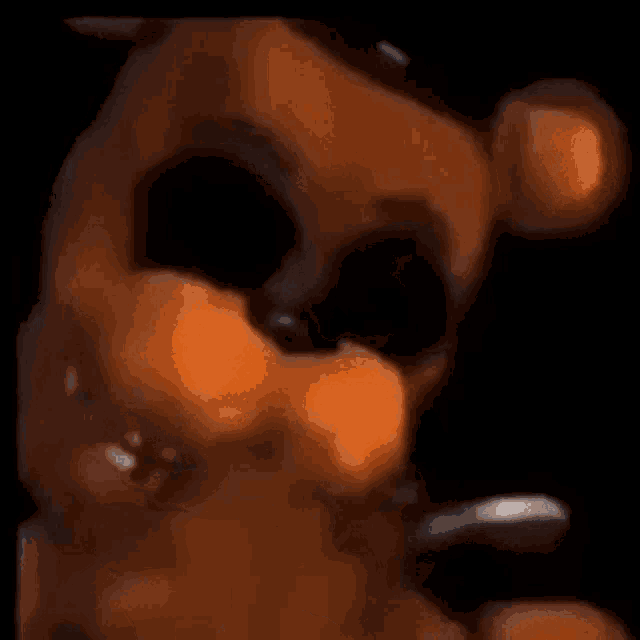 a close up of a cartoon character 's face with a black background .