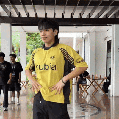 a young man wearing a yellow rubia shirt