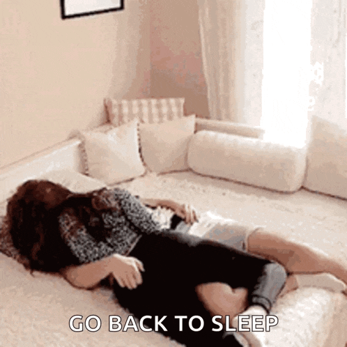 a woman laying on a bed with the words go back to sleep written on the bottom
