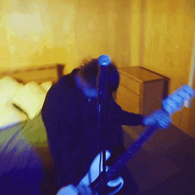 a blurry photo of a man playing a guitar