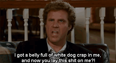 a man in a suit is sitting on a couch and saying " i got a belly full of white dog crap in me